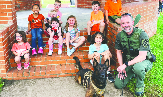 Officer Mike Bucher and his partner, K9 Andor, met with some young library patrons this week. K9 Andor, a Belgian Malinois, was born in the Netherlands and speaks Dutch. He is a dual-purpose canine, certified in narcotics detection and patrol work. He loves to swim, play tug, and go to work. He doesn’t like bad guys or going to bed. Andor’s favorite treats are cheese and bacon-flavored Dentastix. Officer Bucher and K9 Andor’s visit was made possible through the efforts of Ruston Thompson, also a member of the Waco Police Department.

On Tuesday, May 14, the library will host a Family Reading Night at 5:30 pm and welcome United States Marine Alan White and his dog Szva. White is the owner of White Haven Canine Evaluators, a dog evaluation and therapy dog service. Everyone is invited to the library to meet White and Szva.